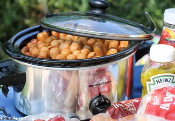 Not everyone wants to be stuck behind a grill during the picnic! If you have to cook hot dogs for a crowd, there's an easy way to do it-in the slow cooker! Crockpot Hot Dogs are a thing, and they are delicious!