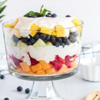 summer fruits with creamy lime dressing in a trifle bowl