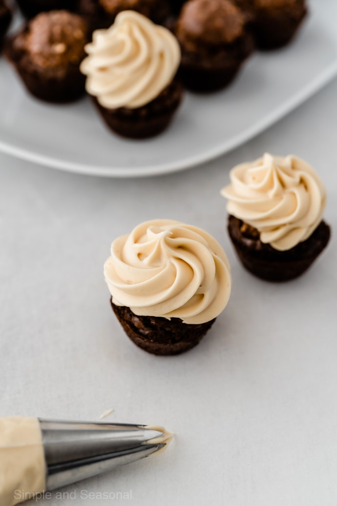 ferrero rocher brownie bite covered with a swirl of caramel frosting