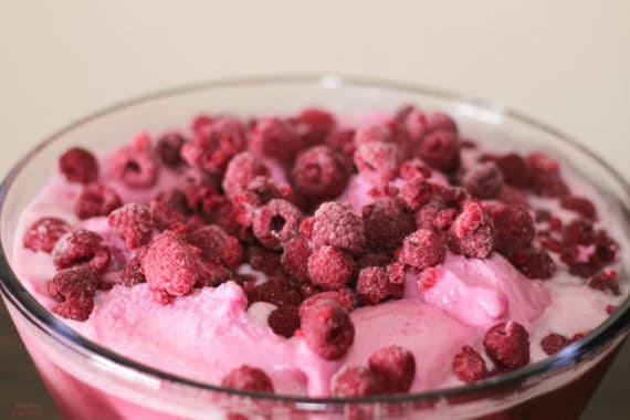 frozen raspberries on top of pink punch