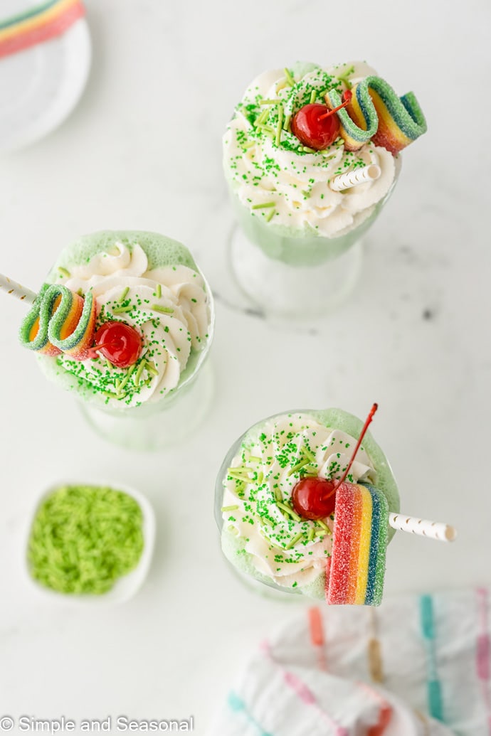 shakes topped with candies, whipped cream and cherries