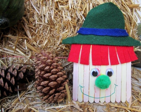 scarecrow craft next to hay bale