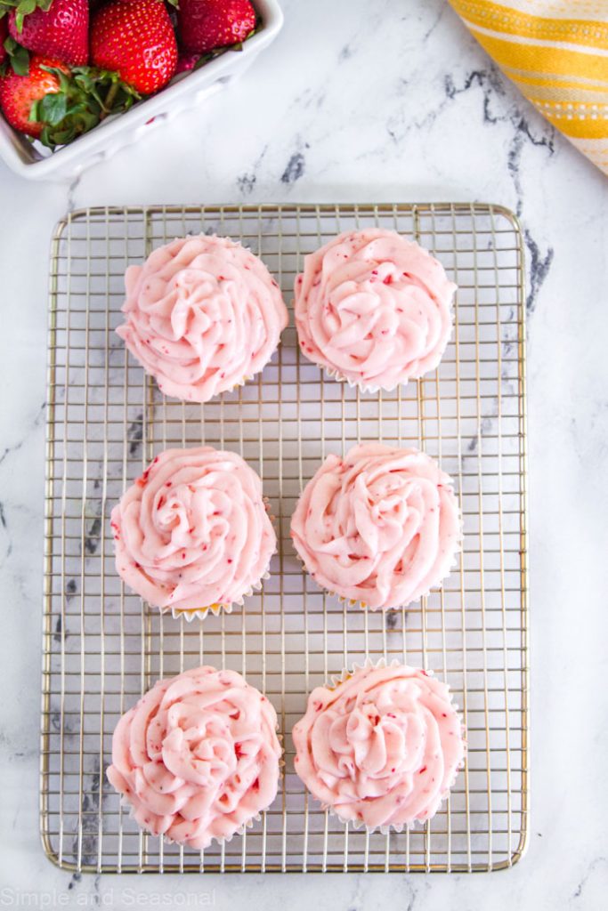 frosted cupcakes on a cooling rack