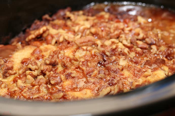 cooked apple dump cake shown in the crock of a slow cooker