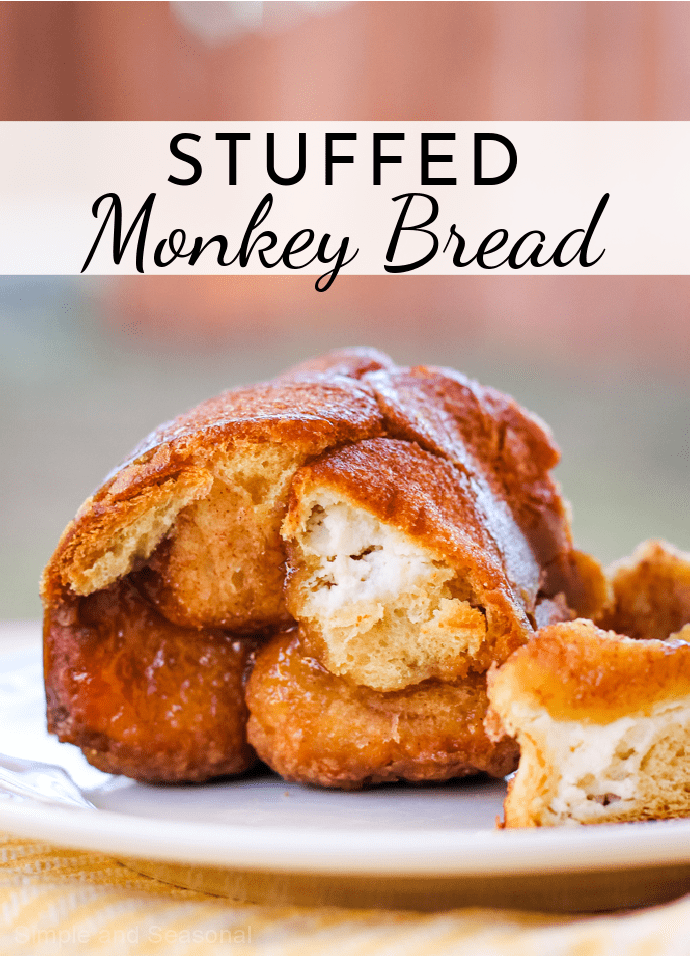 Golden flaky bread, cream cheese filling and a buttery brown sugar syrup make Cream Cheese Stuffed Monkey Bread the perfect treat! via @nmburk