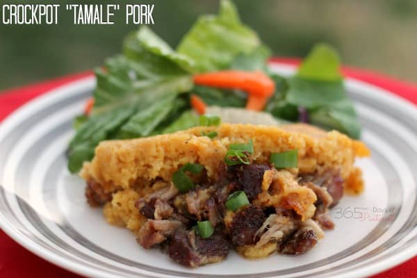 cooked pork shoulder on a plate covered with corn bread topping with salad in the background and text label reading: Crockpot "Tamale" Pork