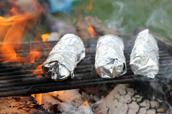 Easy recipes and fun games for a memorable backyard campout like breakfast burritos and campfire churros