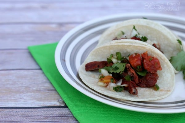 easy pico de gallo recipe tacos on white plate with green napkin