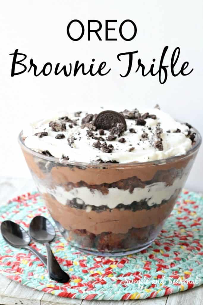 glass bowl filled with layers of OREO Brownie Trifle on colorful placemat with spoons