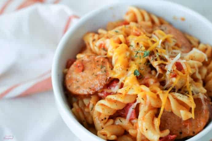 closeup on rotini pasta with cheese and tomato sauce