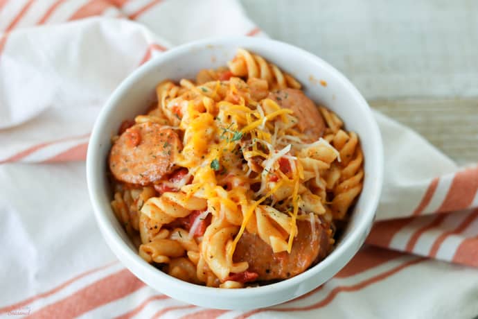 bowl of cooked pasta on a striped towel