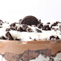 close up of top of layered trifle bowl topped with extra oreo pieces