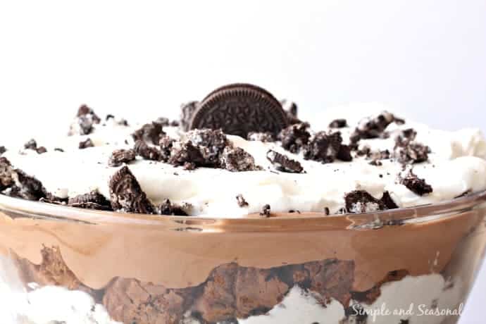 close up of top of layered trifle bowl topped with extra oreo pieces