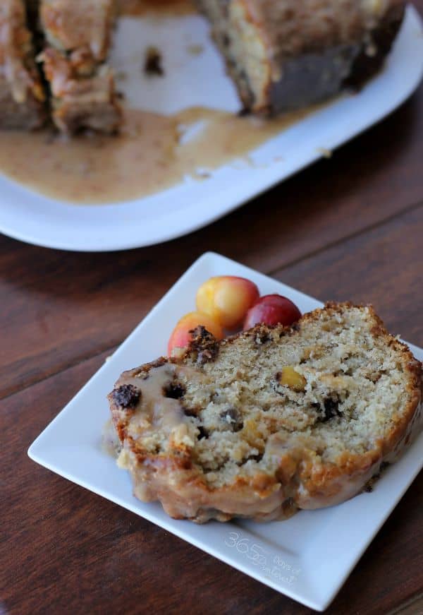 Chocolate cherry banana bread on platter with slice in front