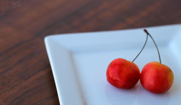 pair of Rainier cherries on a plate