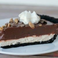 slice of chocolate caramel creme pie on a white plate