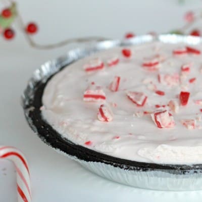 pink and white peppermint candies on top of cheesecake