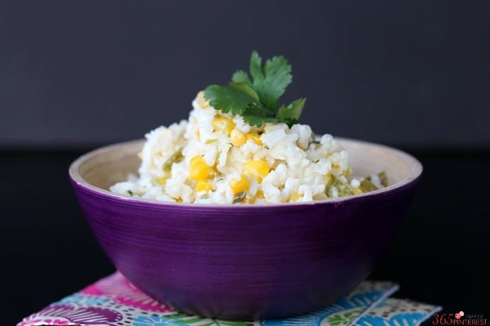 creamy rice topped with fresh cilantro on a black background