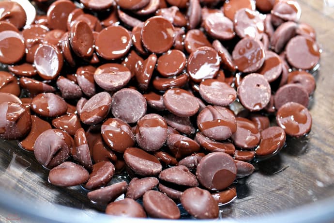 dark chocolate chips in a bowl with coconut oil