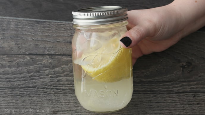 hand holding mason jar with lid on