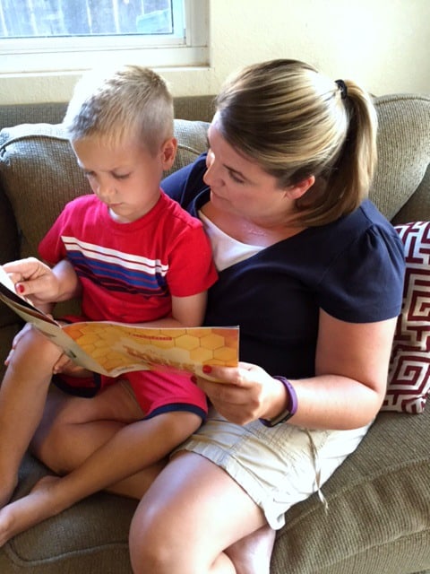 mother reading to son on her lap