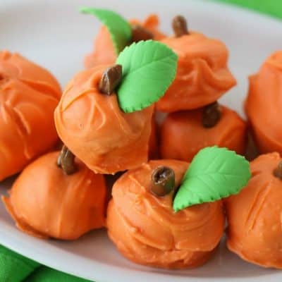 Made with spice cake and cream cheese frosting, these Cake Ball Pumpkins are a perfect party treat for Halloween, Thanksgiving or the Fall Festival!