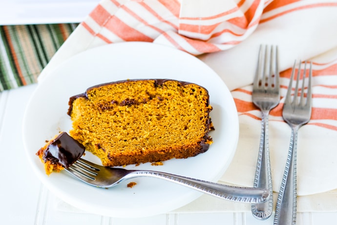 slice of pumpkin bread on a plate with a piece on the fork