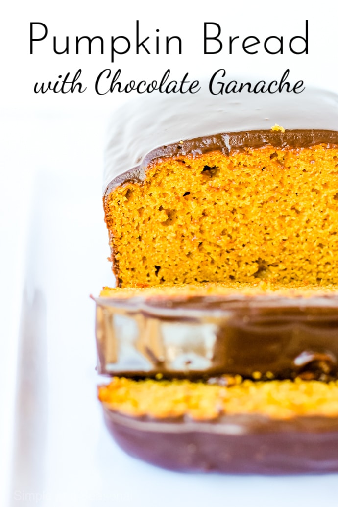 closeup of slice of orange pumpkin bread with shiny chocolate ganache covering the top