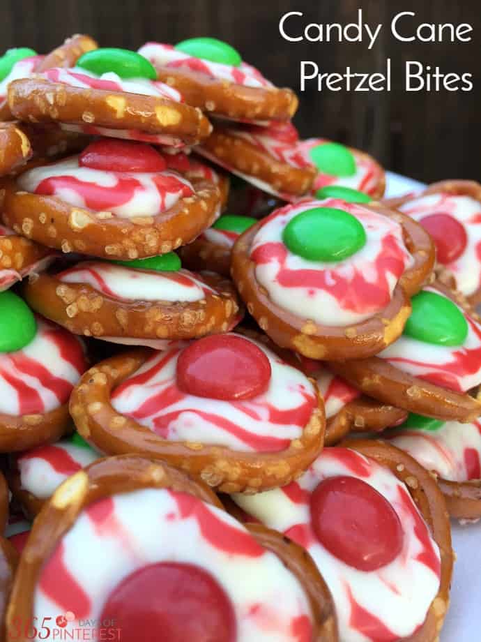 The combination of salty and sweet is what keeps you coming back for more of these Candy Cane Pretzel Bites! Perfect for holiday parties! via @nmburk