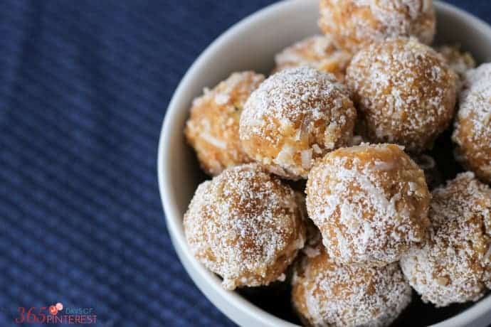 closeup of orange cookie balls rolled in powdered sugar