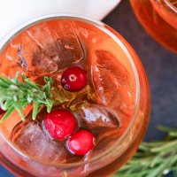top down view of cranberry punch garnished with fresh berries and rosemary sprigs