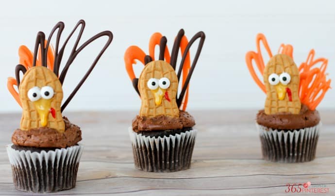 Celebrate Thanksgiving with these adorable little turkey cupcakes! Peanut butter bodies and candy feathers mean you can have turkey for dessert, too. ;)