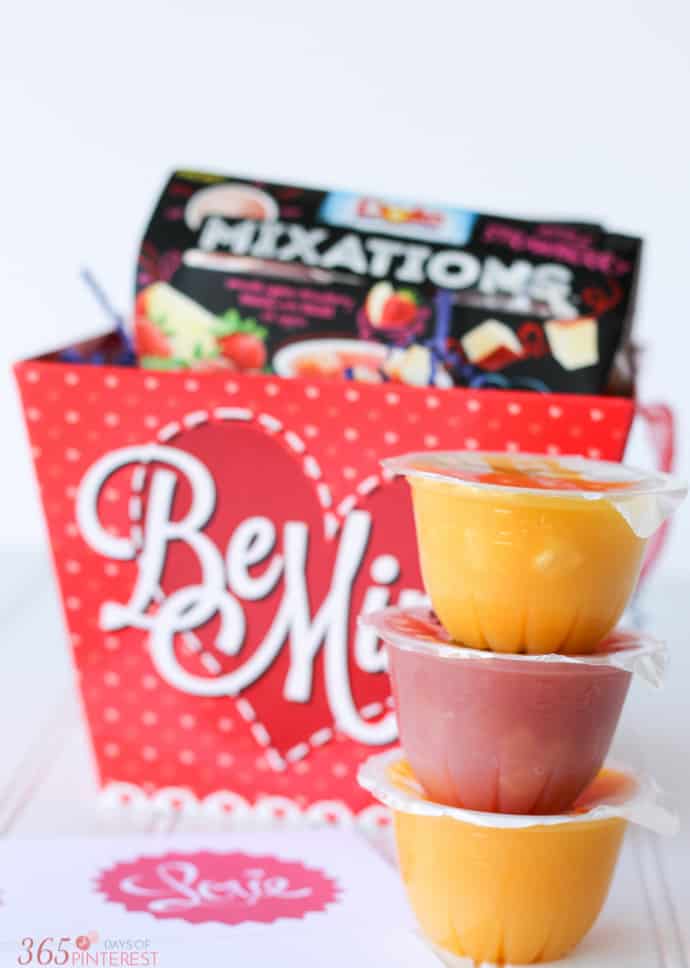 stack of fruit cups in front of a Valentine's Day box