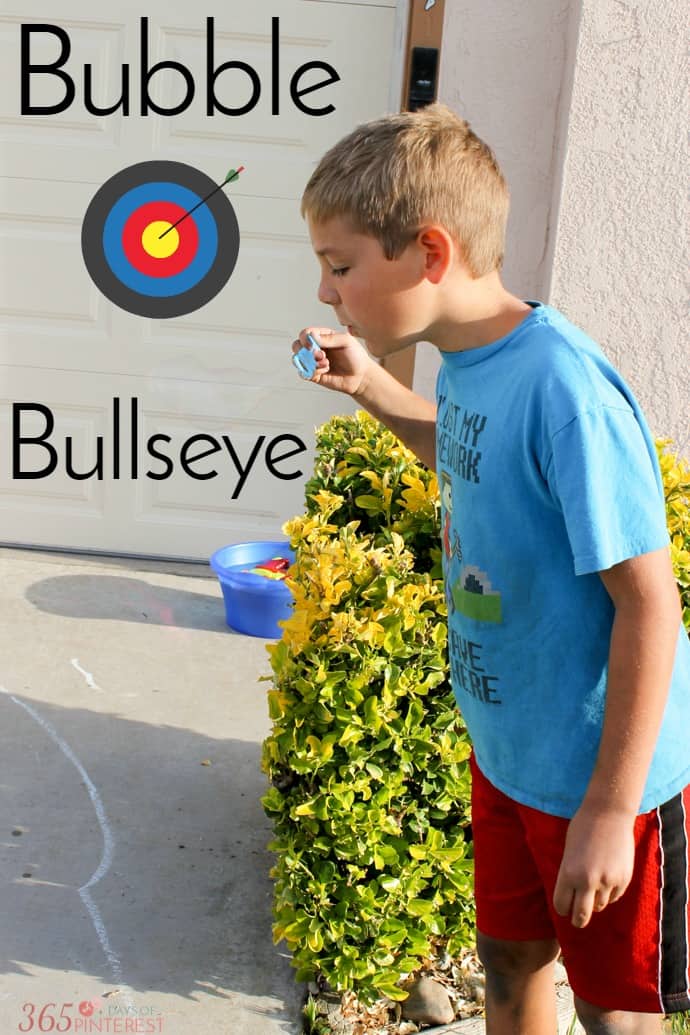 boy playing Bubble Bullseye sidewalk chalk game