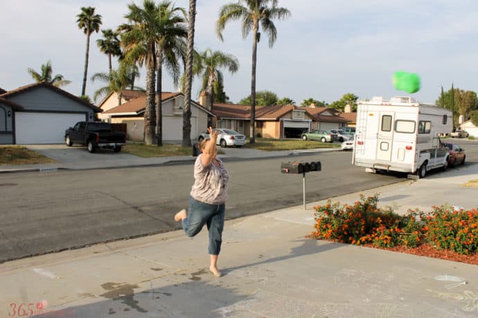 mom tossing a sponge high into the air