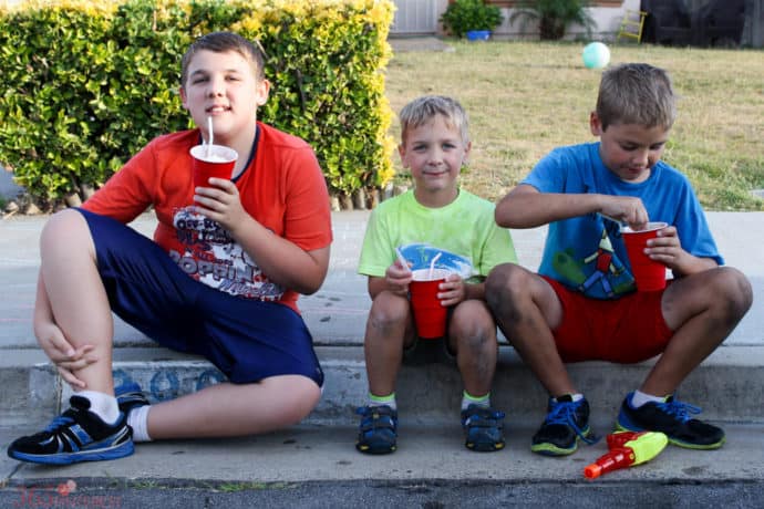 3 boys drinking root beer floats