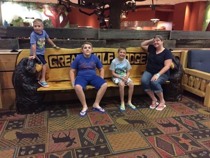family sitting on a bench at Great Wolf Lodge