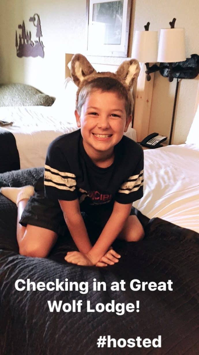 boy on hotel bed wearing wolf ears headband