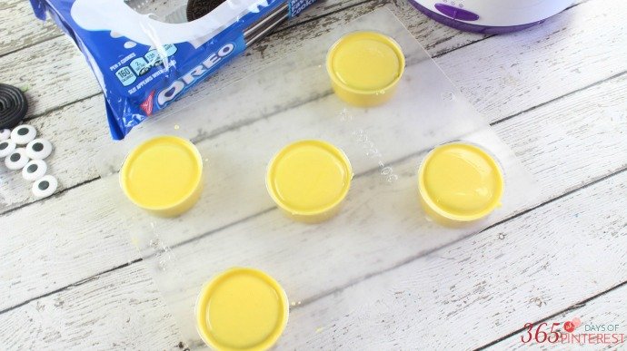 oreos pressed down into melting candy and fully covered in yellow