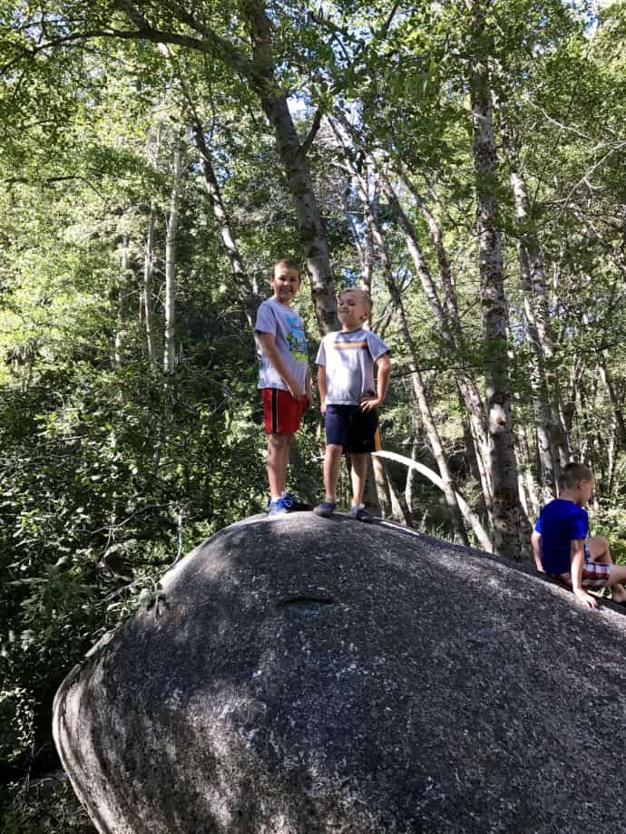 boys on top of a large boulder