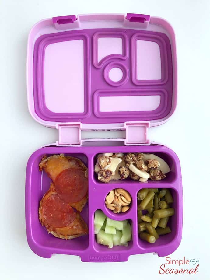 bento box idea: english muffin pizzas, granola, nuts, cucumber and beans