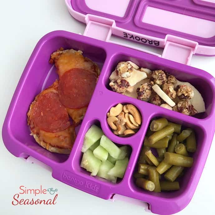 bento box idea: english muffin pizzas, granola, nuts, cucumber and beans