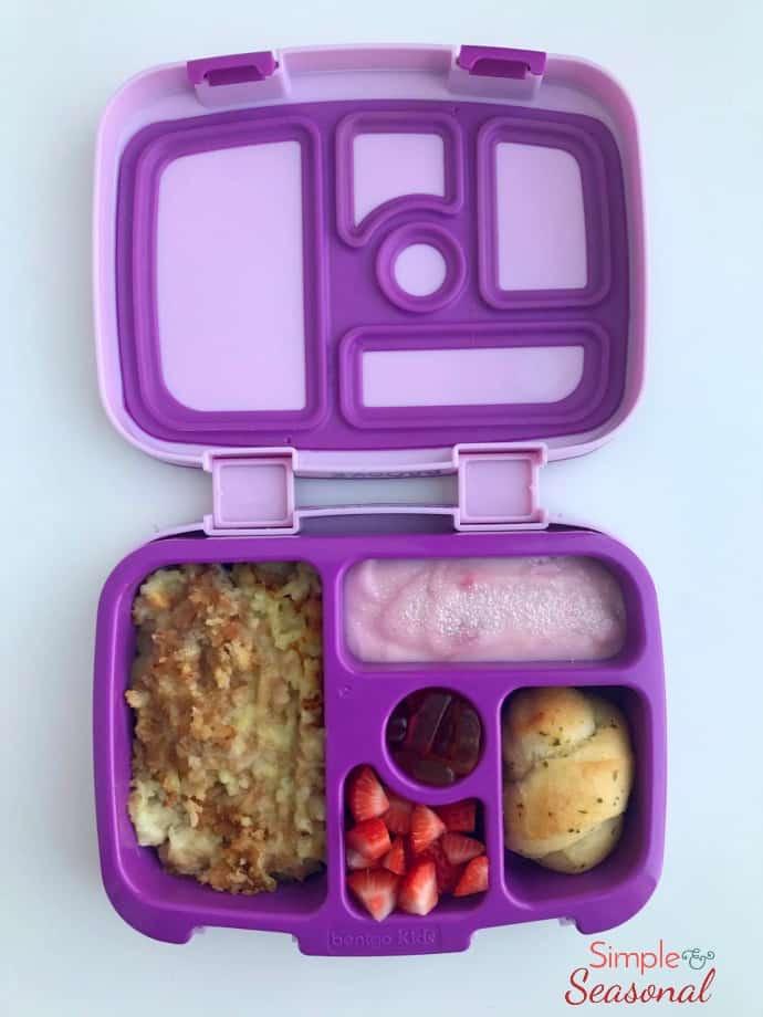 chicken and rice casserole, dinner roll, yogurt, strawberries and fruit snacks