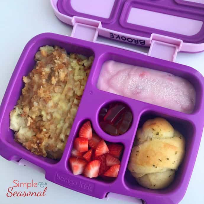 chicken and rice casserole, dinner roll, yogurt, strawberries and fruit snacks