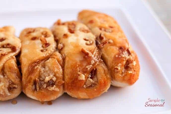 biscuits stuffed with maple cream and topped with nuts on white plate