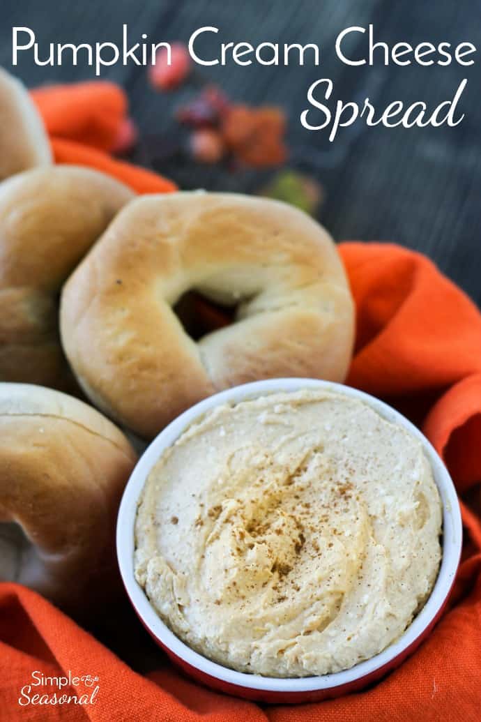 pumpkin cream cheese spread in a basket with mini bagels and orange napkin