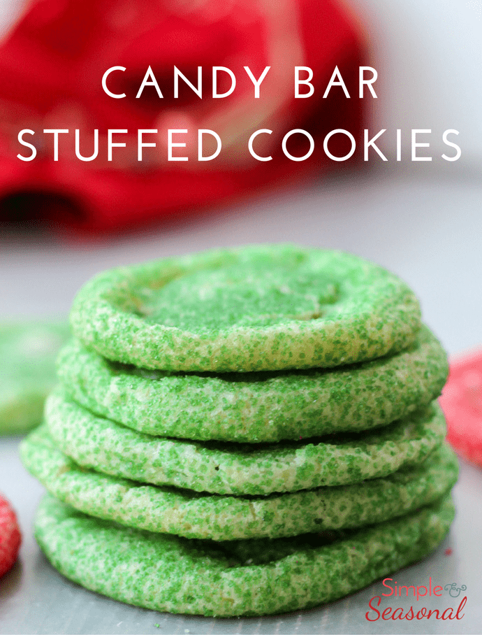 Candy Bar Stuffed Cookies will literally take you five minutes to prep and ten minutes to bake. They are perfect for cookie exchanges or baking with the kids! #ChristmasCookies #Baking #CookieRecipe #EasyRecipe via @nmburk
