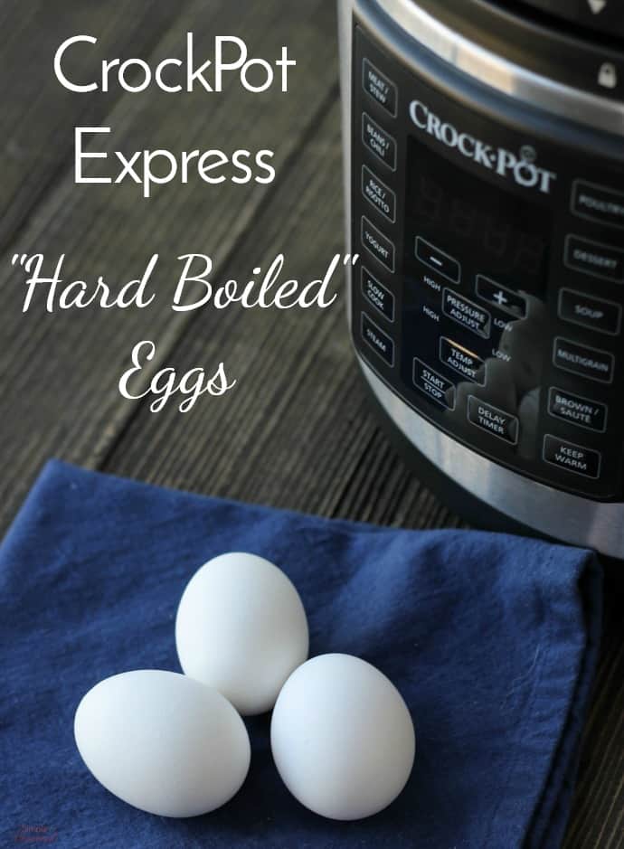 Crockpot Express Hard Boiled Eggs on a blue napkin with pot in the background