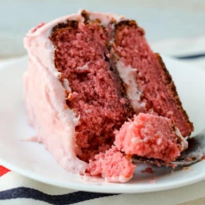 With real strawberries in the cake and the frosting, this Easy Strawberry Cake is perfect for Valentine's Day, Easter or any special celebration! The homemade frosting is good enough to eat with a spoon (and it tastes like a strawberry milkshake.)