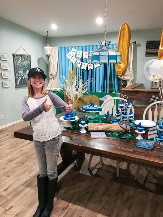 birthday girl and table with Percy Jackson food and snacks